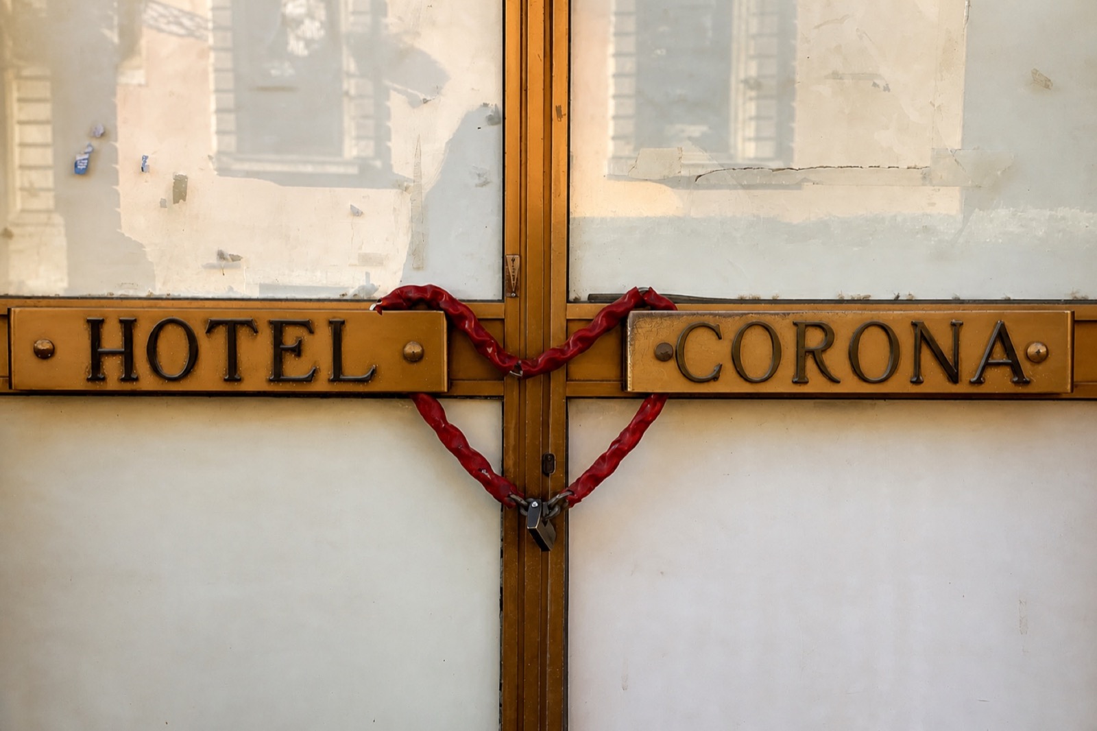 La porte vitrée et cadenassée de l’Hôtel Corona, photographiée par Jérémy